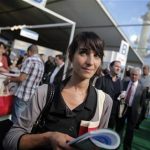 Estelle Borrell, 24, visits a job fair in Paris, Thursday, Oct. 4, 2012. Estelle Borrell knew she wanted to work in law since she was a teenager, when she interned at a court in Versailles, France. "The lawyers in their black robes, they were like gods to me," said the 24-year-old Parisian. Borrell studied law at Vienna University, where she dreamed of putting her passion into practice at an international organization. She got a shock when she began working at a Vienna law firm. (AP Photo/Christophe Ena)