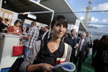 Estelle Borrell, 24, visits a job fair in Paris, Thursday, Oct. 4, 2012. Estelle Borrell knew she wanted to work in law since she was a teenager, when she interned at a court in Versailles, France. "The lawyers in their black robes, they were like gods to me," said the 24-year-old Parisian.  Borrell studied law at Vienna University, where she dreamed of putting her passion into practice at an international organization. She got a shock when she began working at a Vienna law firm.  (AP Photo/Christophe Ena)
