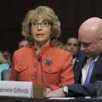 Former Arizona Rep. Gabrielle Giffords, who was seriously injured in the mass shooting that killed six people in Tucson, Ariz. two years ago, sits with her husband Mark Kelly, speaks on Capitol Hill in Washington, Wednesday, Jan. 30, 2013, before the Senate Judiciary Committee hearing on gun violence. (AP Photo/Susan Walsh)