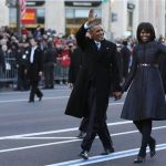 U.S. President Barack Obama and first lady Michelle Obama walk and wave after emerging from the presidential limousine during the inaugural parade from the Capitol to the White House in Washington, January 21, 2013. REUTERS/Larry Downing (UNITED STATES - Tags: POLITICS)