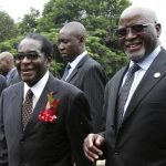 Zimbabwe's President Robert Mugabe (L) walks with his newly sworn-in Vice President John Nkomo (R) at the State House in the capital Harare in this December 14, 2009 file photo. Zimbabwean Vice-President Nkomo died in South Africa on January 17, 2013 after years of battling cancer, a Zimbabwean political source said, removing a potential successor to ageing Mugabe, who has his own health problems. Nkomo, 78, was nominated for the joint number two position alongside Joice Mujuru two years ago after a fractious meeting of the southern African nation's ruling ZANU-PF party. REUTERS/Philimon Bulawayo/Files