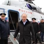 Russian President Vladimir Putin (C) arrives at the town of Krymsk in the Krasnodar region January 11, 2013. REUTERS/Mikhail Klimentyev/RIA Novosti/Pool