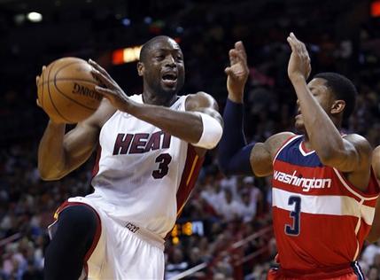 Miami Heat's Dwyane Wade (3) prepares to shoot against Washington Wizards' Bradley Beal (3) during the first half of an NBA basketball game in Miami, Sunday, Jan. 6, 2013. (AP Photo/Alan Diaz)