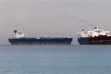 Vessels sail past Malta-flagged Iranian crude oil supertanker "Delvar" (L) anchoring off Singapore March 1, 2012. REUTERS/Tim Chong