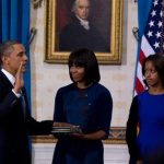 With a portrait of former U.S. President James Madison in the background, U.S. President Barack Obama takes the oath of office as frst lady Michelle Obama holds a bible during the official swearing-in ceremony at the White House in Washington January 20, 2013. The president's eldest daughter Malia is at right. REUTERS/Doug Mills/Pool