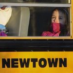A girl sits on a Newtown bus leaving the new Sandy Hook Elementary School after the first day of classes in Monroe, Conn., Thursday, Jan. 3, 2013. The Sandy Hook students started today in a new school, formerly called Chalk Hill School in Monroe. It was renamed Sandy Hook Elementary and overhauled especially for the students from the Sandy Hook School shooting. (AP Photo/Jessica Hill) (AP Photo/Jessica Hill)
