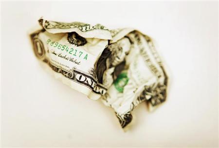 A crumpled U.S. one dollar bill is displayed in Toronto October 22, 2008. REUTERS/Mark Blinch