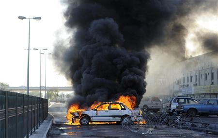 Anti-government protesters set a car on fire to create a road block to mark the second anniversary of the February 14 uprising, in Budaiya, west of Manama, February 14, 2013. REUTERS/Hamad I Mohammed