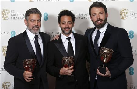 Ben Affleck (R), George Clooney (L) and Grant Heslvov celebrate after winning the Award for Best Film for the movie "Argo" at the British Academy of Film and Arts (BAFTA) awards ceremony at the Royal Opera House in London February 10, 2013. REUTERS/Suzanne Plunkett (BRITAIN - Tags: ENTERTAINMENT) (BAFTA-WINNERS)