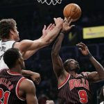 Brooklyn Nets center Brook Lopez (11) tips the ball away from Chicago Bulls forward Luol Deng (9) in the first quarter of their NBA basketball game in New York, February 1, 2013. REUTERS/Ray Stubblebine
