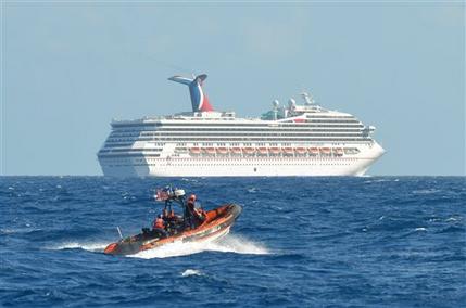 In this image released by the U.S. Coast Guard on Feb. 11, 2013, a small boat belonging to the Coast Guard Cutter Vigorous patrols near the cruise ship Carnival Triumph in the Gulf of Mexico, Feb. 11, 2013. The Carnival Triumph has been floating aimlessly about 150 miles off the Yucatan Peninsula since a fire erupted in the aft engine room early Sunday, knocking out the ship's propulsion system. No one was injured and the fire was extinguished. (AP Photo/U.S. Coast Guard- Lt. Cmdr. Paul McConnell)