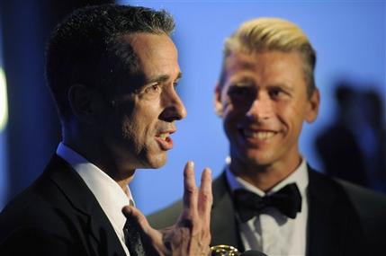 FILE - In this Sept. 15, 2012 file photo, Dan Savage, left, and Terry Miller pose backstage with the Governors Award for the "It Gets Better Project" at the 2012 Creative Arts Emmys at the Nokia Theatre in Los Angeles. A new Pediatrics study found scientific evidence that it does get better for gay teens, when it comes to bullying, although young gay men fare worse than their lesbian peers. (Photo by Chris Pizzello/Invision/AP)