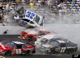 Kyle Larson (32) goes into the catch fence as he collides with Justin Allgaier (31), Brian Scott (2), Parker Klingerman (77) and Dale Earnhardt Jr. (88) at the conclusion of the NASCAR Nationwide Series auto race Saturday, Feb. 23, 2013, at Daytona International Speedway in Daytona Beach, Fla. (AP Photo/Terry Renna)