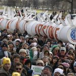 Demonstrators carry a replica of a pipeline during a march against the Keystone XL pipeline in Washington, February 17, 2013. REUTERS/Richard Clement