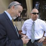 In this Sept. 6, 2012 file photo, Joel Brodsky, left, and Steven Greenberg, attorneys for former Bolingbrook police officer Drew Peterson, confer outside the Will County Courthouse in Joliet, Ill., during the jury deliberations in Peterson's murder trial. The open lawyerly warfare between Brodsky, the lead counsel and co-counsel Greenberg, who also played a central role in the high-profile case, comes to a head Tuesday, Feb. 19, 2013, at a hearing where a judge will decide if Peterson should get a new trial on grounds that the lead trial attorney allegedly did a shoddy job. (AP Photo/Paul Beaty, File)