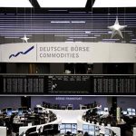 Traders are pictured at their desks in front of the DAX board at the Frankfurt stock exchange January 4, 2013. REUTERS/Remote/Joachim Herrmann