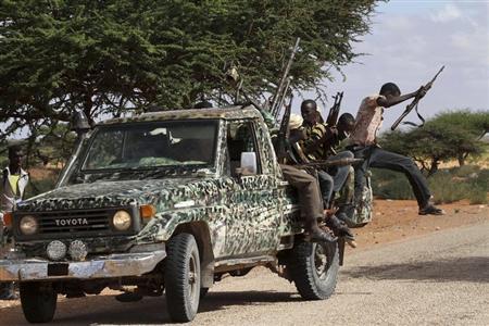 Fighters from the moderate Ahlu Sunna forces arrive at a road checkpoint outside Mareergur town, 30 km (19 miles) to the north of Dhusamareeb, in central Somalia December 17, 2012. REUTERS/Feisal Omar