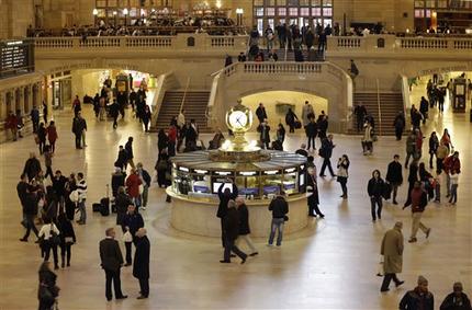 FILE- In this Jan. 9, 2013 file photo, pedestrians and travelers stroll through the main concourse of Grand Central Terminal in New York. The landmark, one of the country's finest examples of Beaux Arts architecture and the most famous train station in America is celebrating it's 100th anniversary on February 1. (AP Photo/Kathy Willens, File)