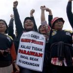 In this Friday, Dec. 21, 2012 photo, Indonesian women shout slogans during a protest demanding District Chief Aceng Fikri to step down, in Garut, West Java, Indonesia. The Supreme Court late last month recommended that the president dismiss Fikri for violating the marriage law, following a public outrage after he divorced his second teenage wife by text message just four days after their wedding. The response has been seen as a small step forward for women's rights in the secular country where most people practice a moderate form of Islam. The writings on the poster reads "Garut District Chief must step down or there will be no more virgins." (AP Photo/Kusumadireza)