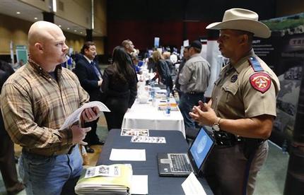 Job Seeker Brett Culver, left, of Newalla, Okla., formerly of the Air Force, talks with Texas state trooper Deon Cockrell, right, at a Recruit Military job fair in Oklahoma City, Thursday, Jan. 31, 2013.  Although veterans as a whole have a lower unemployment rate than the nation at large, younger veterans who served in the years following the Sept. 11 attacks are having a much harder time finding work.   (AP Photo/Sue Ogrocki)