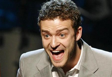 Singer Justin Timberlake reacts as he holds two of his awards for songs "My Love" and "Until the End of Time" during the 25th Annual ASCAP Pop Music Awards at the Kodak Theatre in Hollywood, California, April 9, 2008. REUTERS/Danny Moloshok