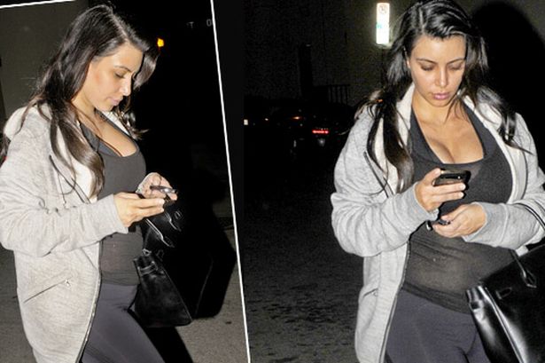 There's the bump! Kim Kardashian shows off her pregnancy kurves in lycra workout wear