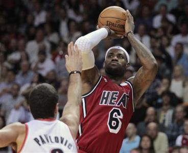 Portland Trail Blazers' Aleksandar Pavlovic (L) defends as Miami Heat's LeBron James shoots in the first half of their NBA basketball game in Miami, Florida February 12, 2013. REUTERS/Andrew Innerarity