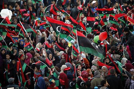 People wave Libyan flags during celebrations commemorating the second anniversary of the country's February 17 revolution, at Martyrs' Square in Tripoli February 17, 2013. REUTERS/Ismail Zitouny