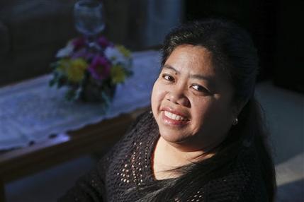 Maricris Arce poses for a picture at her home in Anaheim, Cailf.,Friday, Feb. 15, 2013.  Arce,  a native of the Philippines, said she was separated from her husband for five years after coming legally to the U.S., and he wasn't present for the birth of their first child.  (AP Photo/Chris Carlson)