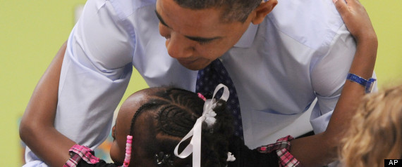 United States President Barack Obama gets a hug from a child at College Heights Early Childhood Learning Center, in Decatur, Ga., on Thursday, Feb. 14, 2013. He visited the school to highlight their pre-kindergarten program. He is proposing a nationwide initiative for children in pre-kindergarten.  (AP Photo/Atlanta Journal-Constitution, Johnny Crawford, Pool)