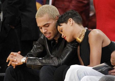 ding artist Rihanna leans her head on Chris Brown as they sit together courtside at the NBA basketball game between the New York Knicks and Los Angeles Lakers in Los Angeles December 25, 2012. REUTERS/Danny Moloshok