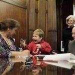 In this photo provided by the Governor's office, from right to left, Alabama Gov. Robert Bentley and First Lady Dianne Bentley watch as Ethan Gilman shows his mother, Jennifer Kirkland, a toy mouse Bentley gave him to play with on a visit to the Governor's Office in Montgomery, Ala. on Wednesday, Feb. 13, 2012. Ethan was held hostage in an underground bunker in a near week-long standoff in Midland City, Ala. (AP Photo/Alabama Governor's Office, Jamie Martin)
