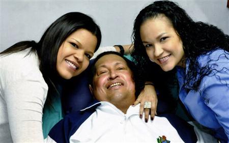 Venezuela's President Hugo Chavez smiles in between his daughters, Rosa Virginia (R) and Maria while recovering from cancer surgery in Havana in this photograph released by the Ministry of Information on February 15, 2013. REUTERS/Ministry of Information/Handout