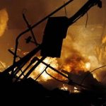 Fire and smoke rise at an upscale shopping district in Kansas City, Mo., where a city official said a gas explosion sparked a block-engulfing blaze, Tuesday evening, Feb. 19, 2013. (AP Photo/The Kansas City Star, Keith Myers) KANSAS CITY OUT