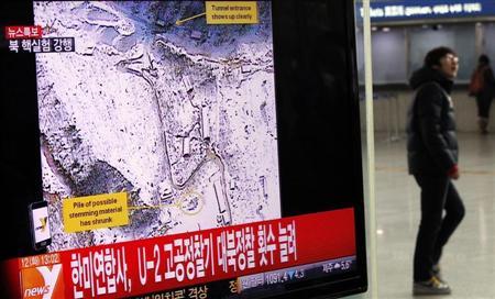 A passenger walks past a television report on North Korea's nuclear test at a railway station in Seoul February 12, 2013. REUTERS/Kim Hong-Ji