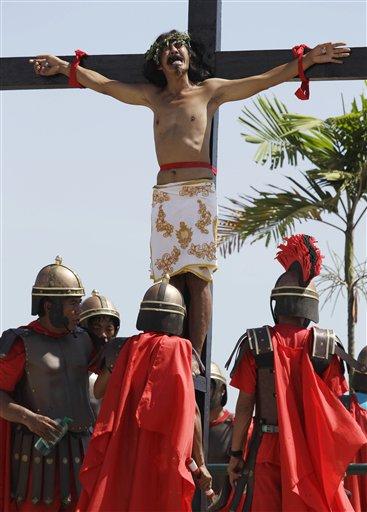 A Filipino penitent shouts as his hands and feet are nailed to the cross during  Good Friday rituals on March 29, 2013 at Cutud, Pampanga province, northern Philippines. Several Filipino devotees had themselves nailed to crosses Friday to remember Jesus Christ's suffering and death, an annual rite rejected by church leaders in this predominantly Roman Catholic country. (AP Photo/Aaron Favila)