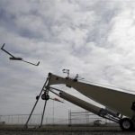 This photo taken March 26, 2013, shows an Insitu ScanEagle unmanned aircraft launched at the airport in Arlington, Ore. Its a good bet that in the not-so-distant future aerial drones will be part of Americans everyday lives, performing countless useful functions. A far cry from the killing machines whose missiles incinerate terrorists, these generally small unmanned aircraft will help farmers more precisely apply water and pesticides to crops, saving money and reducing environmental impacts. Theyll help police departments to find missing people, reconstruct traffic accidents and act as lookouts for SWAT teams. Theyll alert authorities to people stranded on rooftops by hurricanes, and monitor evacuation flows. (AP Photo/Don Ryan)
