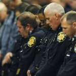 Law enforcement officers bow their head during the memorial of Tom Clements. The public memorial for the chief executive of the Department of Corrections was held at New Life Church in Colorado Springs, Colo., on Monday, March 25, 2013. Tom Clements was shot and killed on the doorstep of his home last week in Monument, Colorado (AP Photo/The Gazette, Jerilee Bennett, Pool)