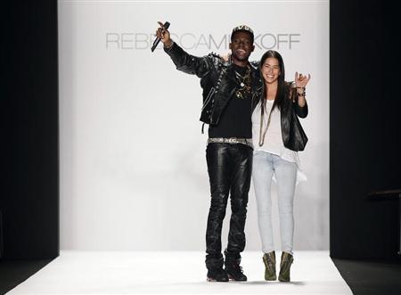 Designer Rebecca Minkoff smiles and waves with a musician after presenting her Fall/Winter 2012 collection during New York Fashion Week February 10, 2012. REUTERS/Lucas Jackson