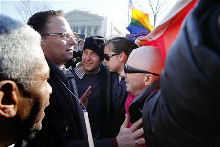 Anti-gay marriage protesters (L) try to convince Proposition 8 opponents (R) to get out of the way of their march in front of the U.S. Supreme Court in Washington, March 26, 2013. REUTERS/Jonathan Ernst