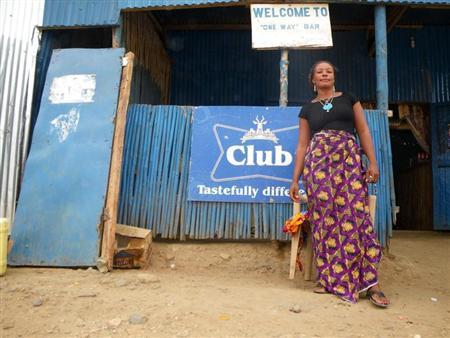 A Congolese bar worker stands outside her place of work, one of the hundreds of small local bars SABMiller hopes will soon be serving their new south Sudanese lager, in Juba March 18, 2009. REUTERS/Skye Wheeler