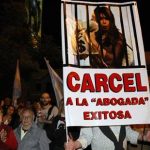 Protesters hold a poster with an image depicting Argentine President Cristina Fernandez de Kirchner behind bars during a demonstration outside the Olivos presidential house in Buenos Aires April 18, 2013. REUTERS/Agustin Marcarian