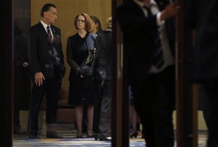 Australia's Prime Minister Julia Gillard (2nd L) talks with Australia's Trade Minister Craig Emerson (L) as they wait for a welcoming lunch during the Australia China Economic and Trade Forum at a hotel in Beijing April 9, 2013. REUTERS/Kim Kyung-Hoon