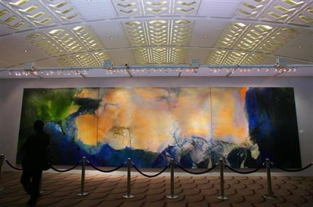 A visitor looks at a 2.8-metre by 10-metre triptych by Chinese painter Zao at Christie's auction house in Hong Kong. REUTERS/Bobby Yip