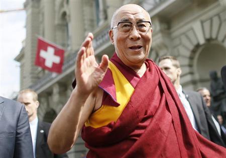 Tibet's exiled spiritual leader the Dalai Lama waves to spectators outside the Swiss Parliament building during his visit to Bern April 16, 2013. REUTERS/Pascal Lauener