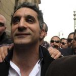Bassem Youssef (C), the country's best-known satirist, gestures to journalists and activists as he arrives at the high court to appear at the prosecutor's office in Cairo March 31, 2013. REUTERS/Mohamed Abd El Ghany