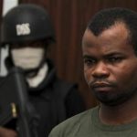Kabiru Sokoto, a suspect in a Christmas Day bomb attack of St. Theresa Catholic Church in Madalla near Nigeria's capital, is guarded by a security official inside the state security service office in the capital Abuja February 10, 2012. REUTERS/Afolabi Sotunde