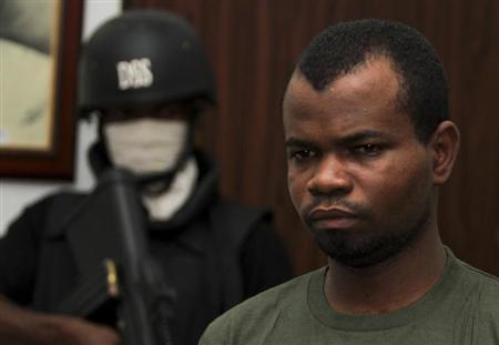 Kabiru Sokoto, a suspect in a Christmas Day bomb attack of St. Theresa Catholic Church in Madalla near Nigeria's capital, is guarded by a security official inside the state security service office in the capital Abuja February 10, 2012. REUTERS/Afolabi Sotunde