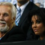 Singer Kenny Rogers and his wife Wanda Miller watch the match between Rafael Nadal of Spain and Marin Cilic of Croatia at the Australian Open tennis tournament in Melbourne January 24, 2011. REUTERS/Tim Wimborne
