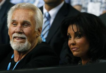 Singer Kenny Rogers and his wife Wanda Miller watch the match between Rafael Nadal of Spain and Marin Cilic of Croatia at the Australian Open tennis tournament in Melbourne January 24, 2011. REUTERS/Tim Wimborne